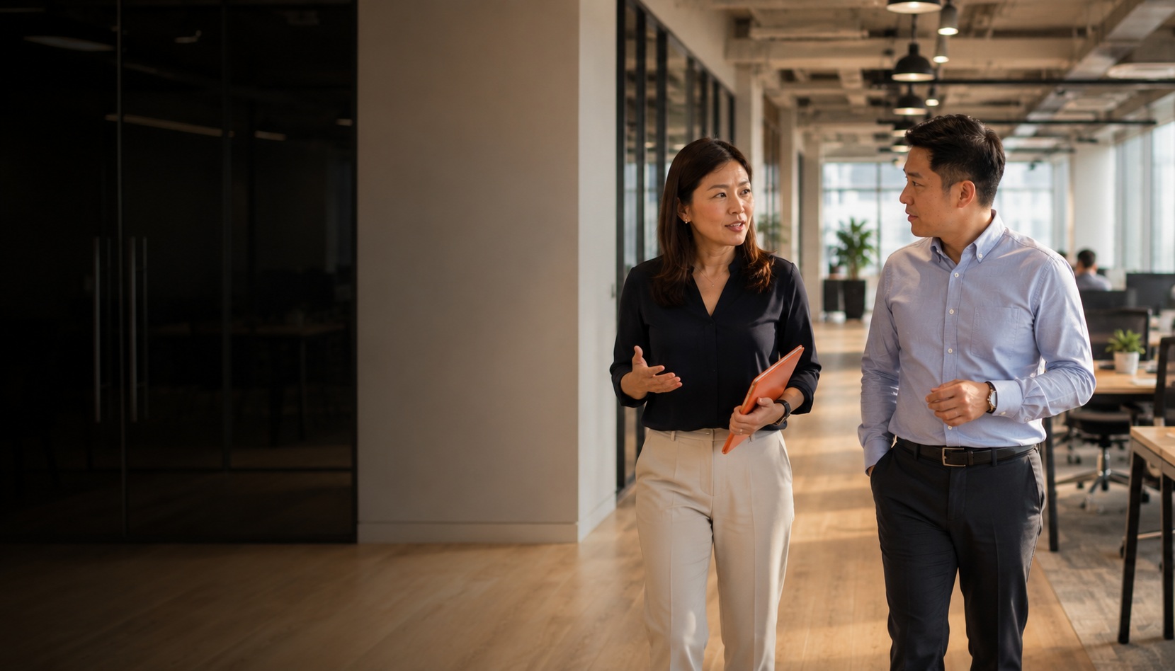 HR Shared Services Thailand — People Profilers HR consultant walking with client through a Thailand office, mid-conversation about HR services